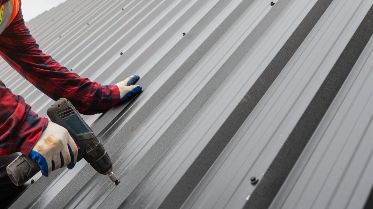 Roofer fitting metal roof sheet