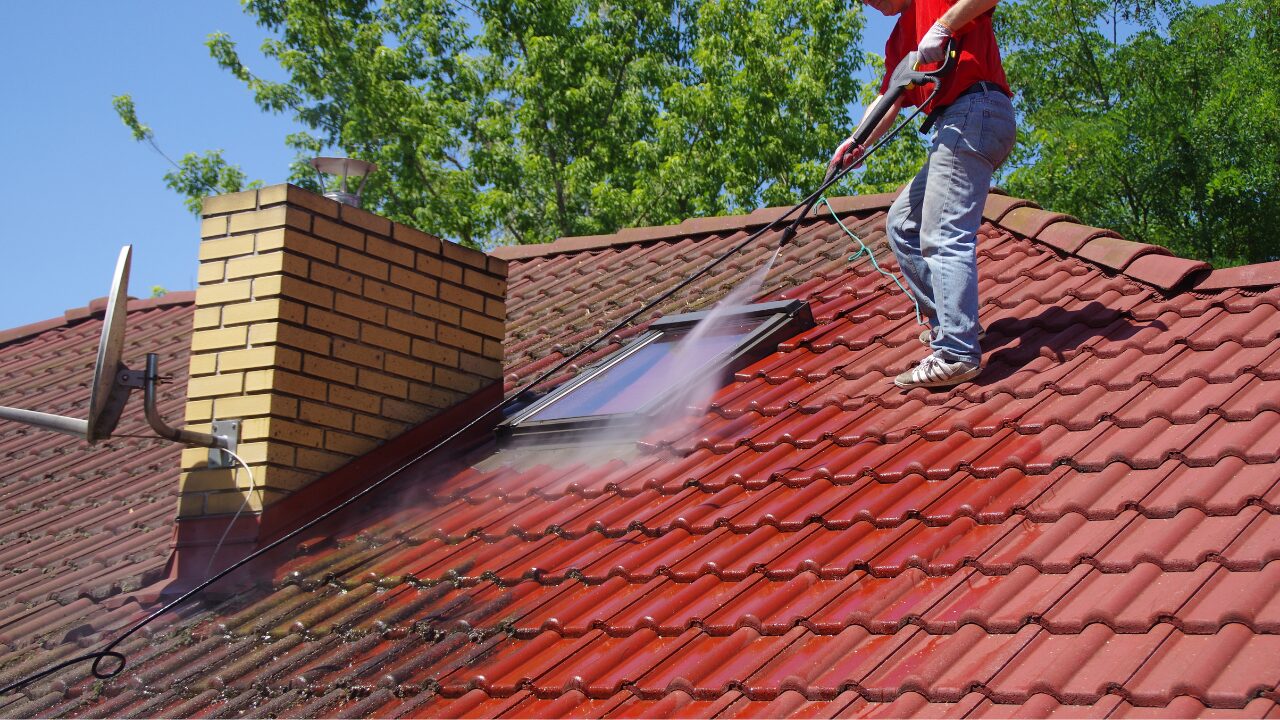 Pressure cleaning roof surface
