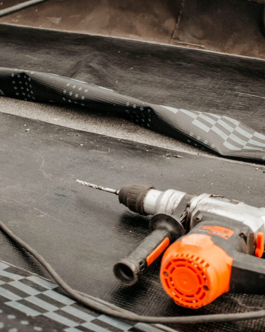 Roofer repairing roof using tools
